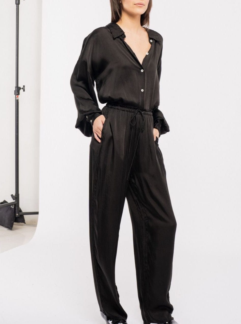 The model is wearing a sustainable black silk Leonie Pant - Black made with Bemberg cupro.