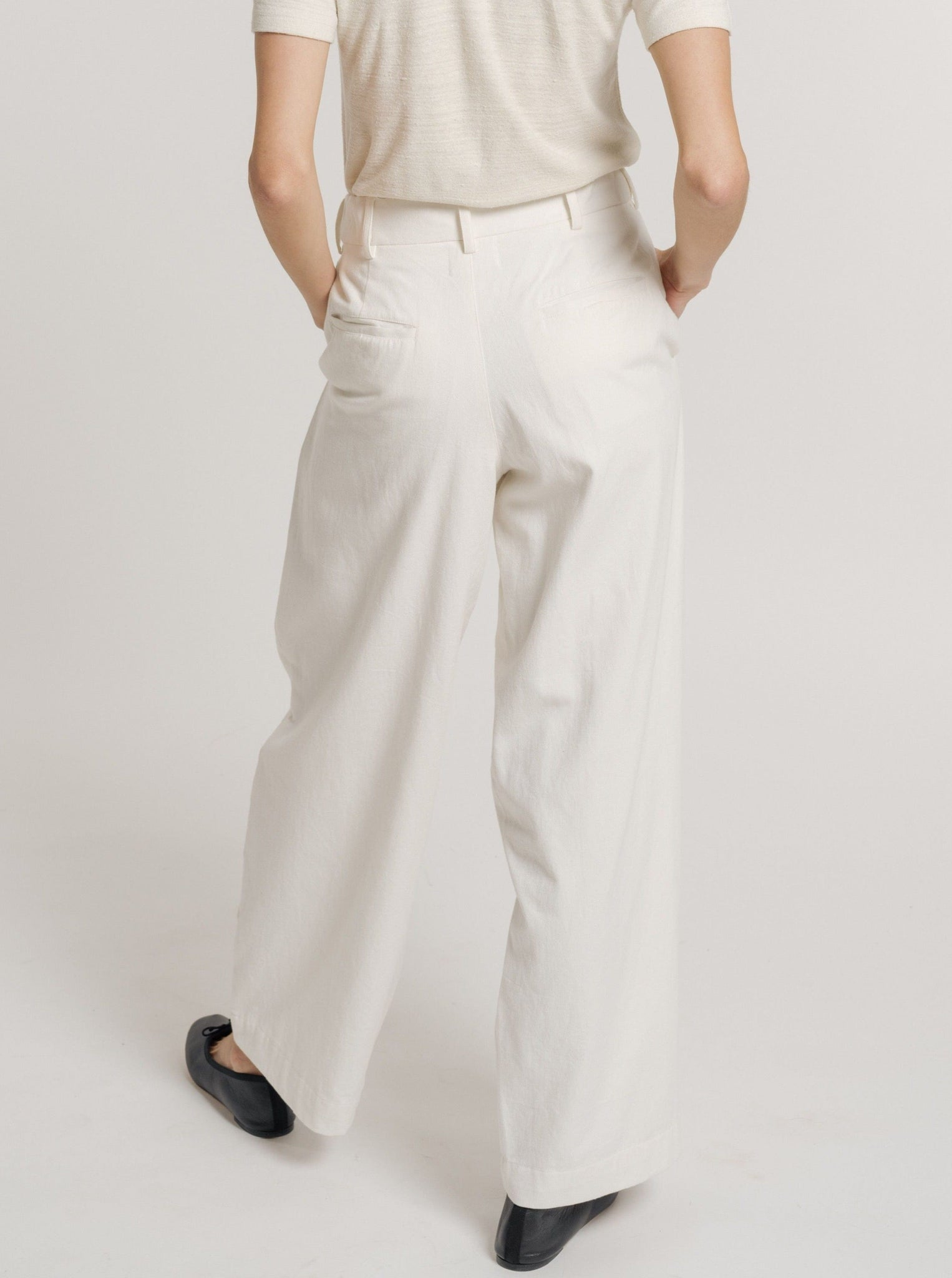 The back view of a woman wearing Alfred Trouser - Ivory with an elasticized waist.