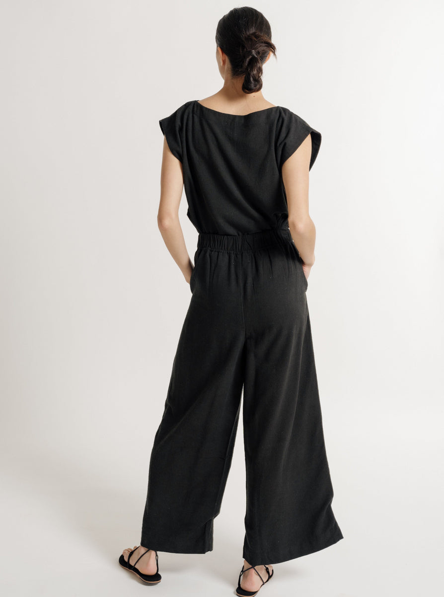 The sustainable back view of a woman wearing the Everyday Pant - Black Silk Noil - Pre-order.