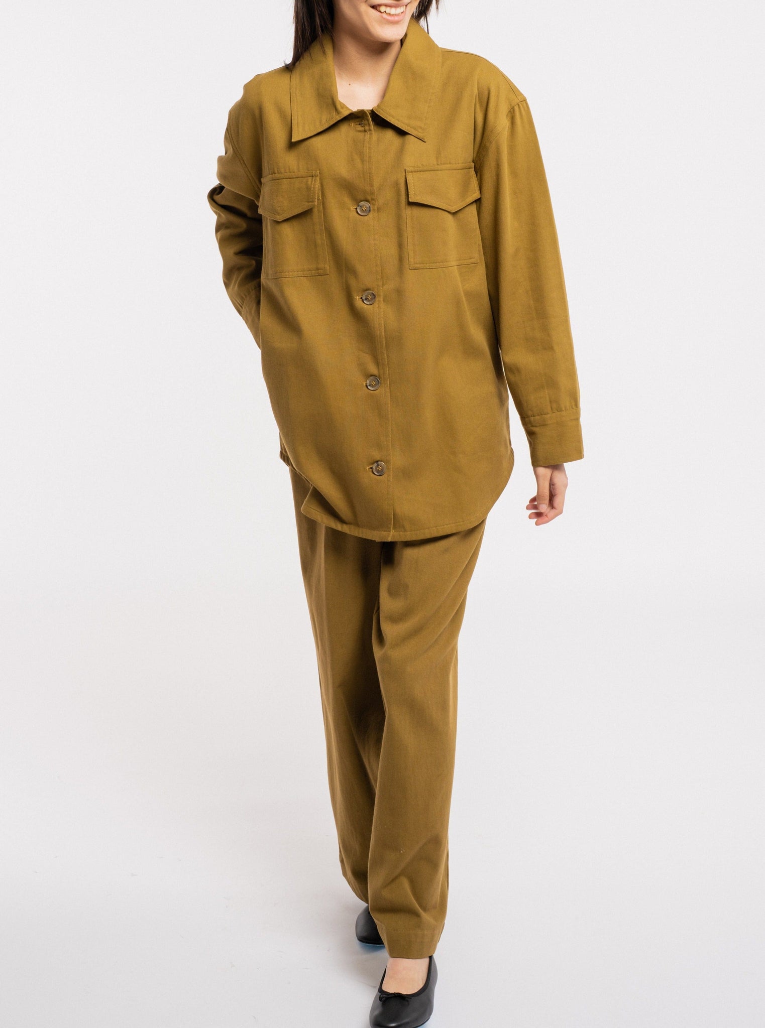 A woman wearing a Roan Shirt Jacket - Olive.
