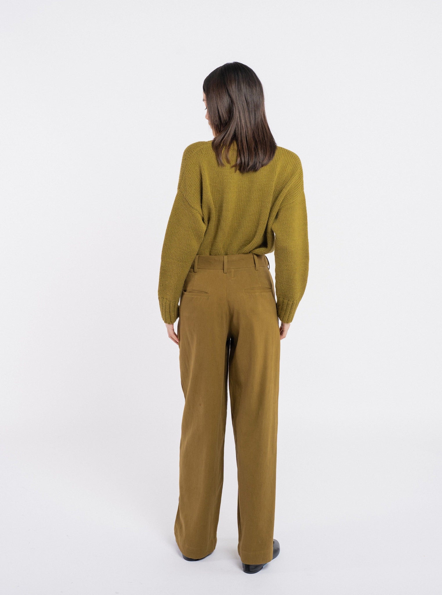 The back view of a woman wearing the Alfred Trouser - Olive.