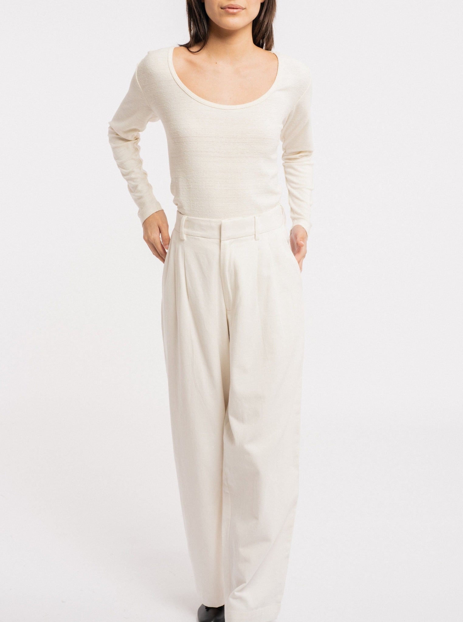 The model is wearing a Ballet Scoop Tee - Ivory - pre-order and wide leg pants.