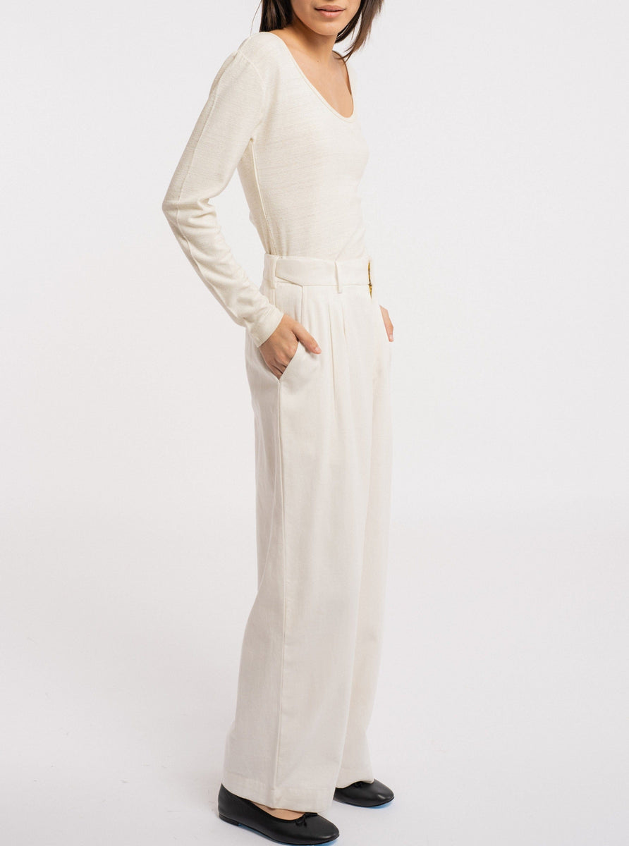 The model is wearing a Ballet Scoop Tee - Ivory - pre-order and wide-leg pants.