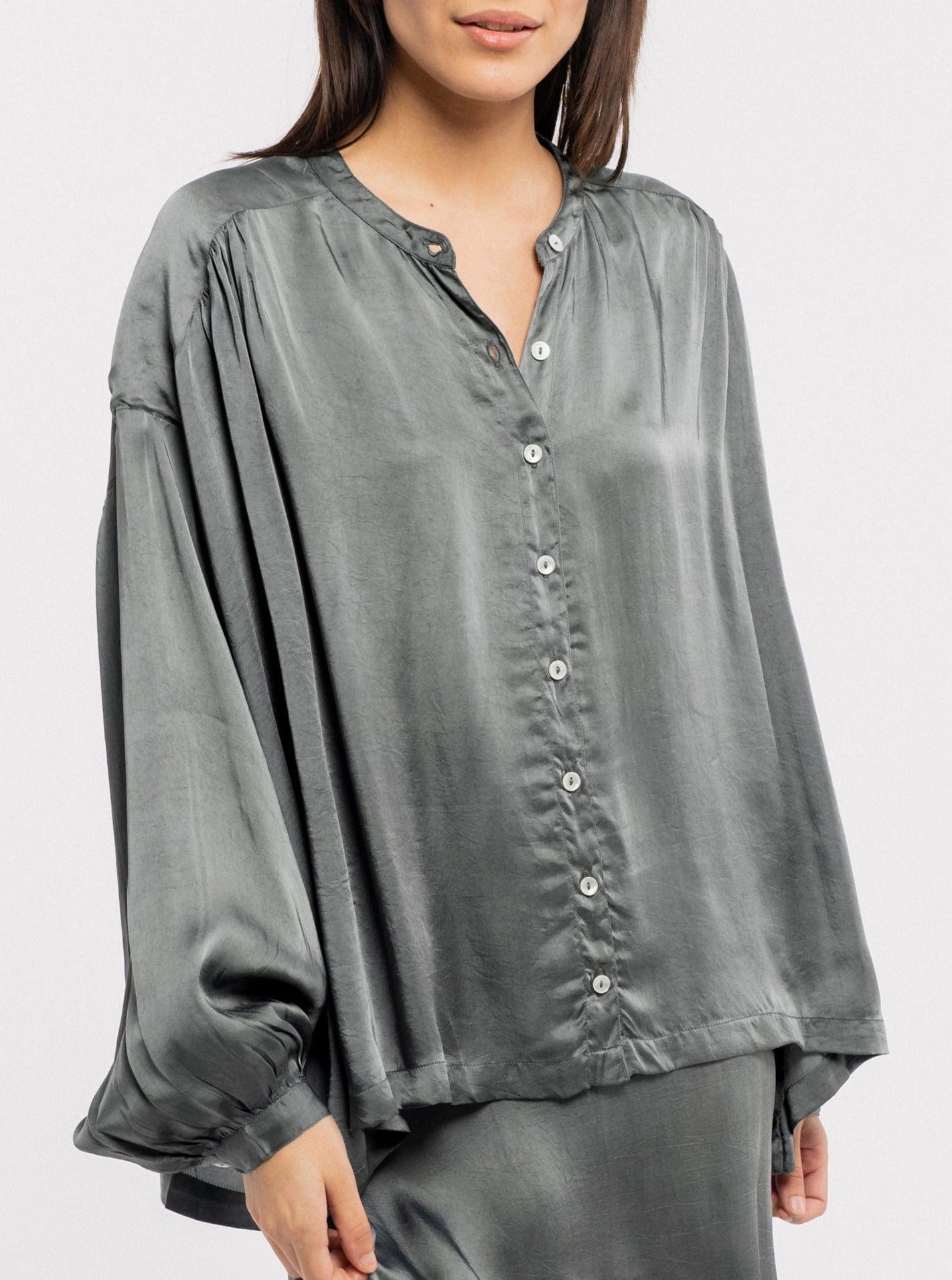 The model is wearing a sustainable grey silk Francoise Top - Slate.