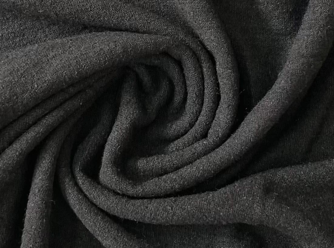 A sustainable close up image of a Ballet Scoop Tee - Black fabric.
