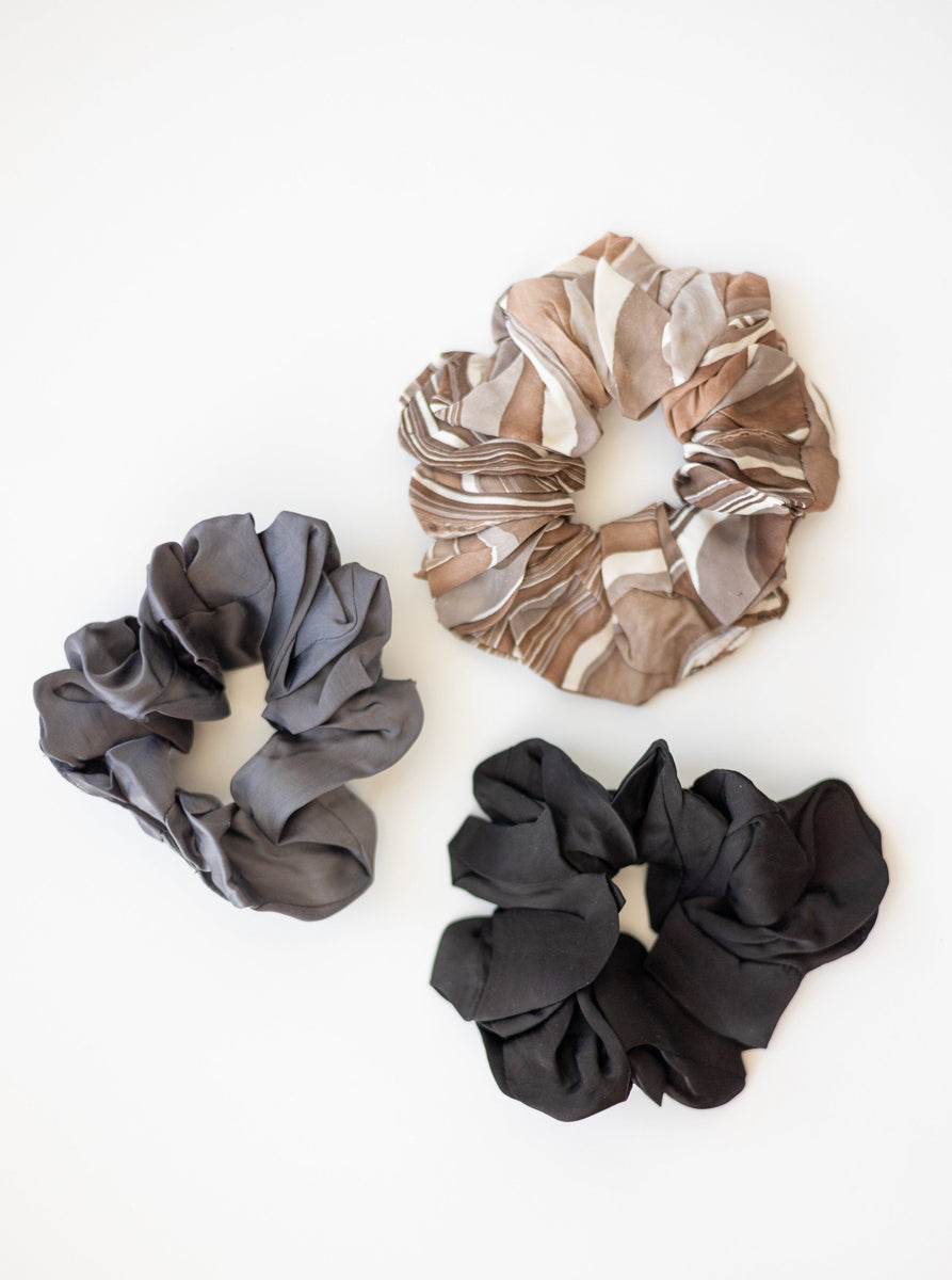 A Small Scrunchy (set of 3) made from remnant fabrics is displayed on a pristine white surface.
