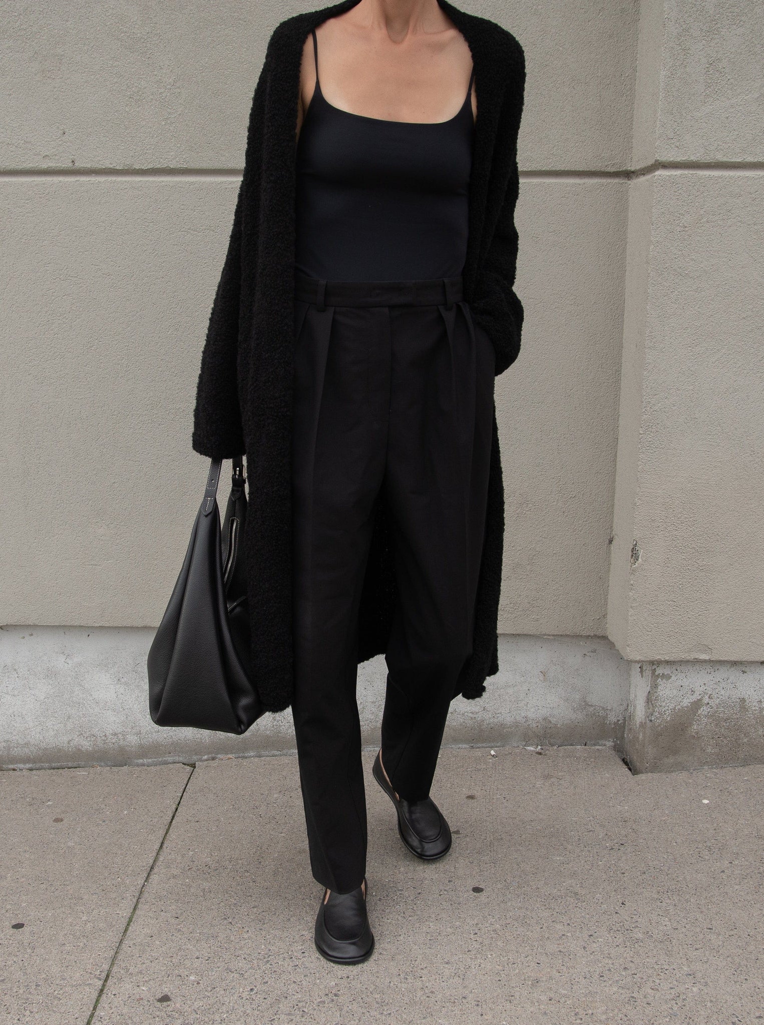 A woman wearing the Heirloom Sweater Coat - Black.