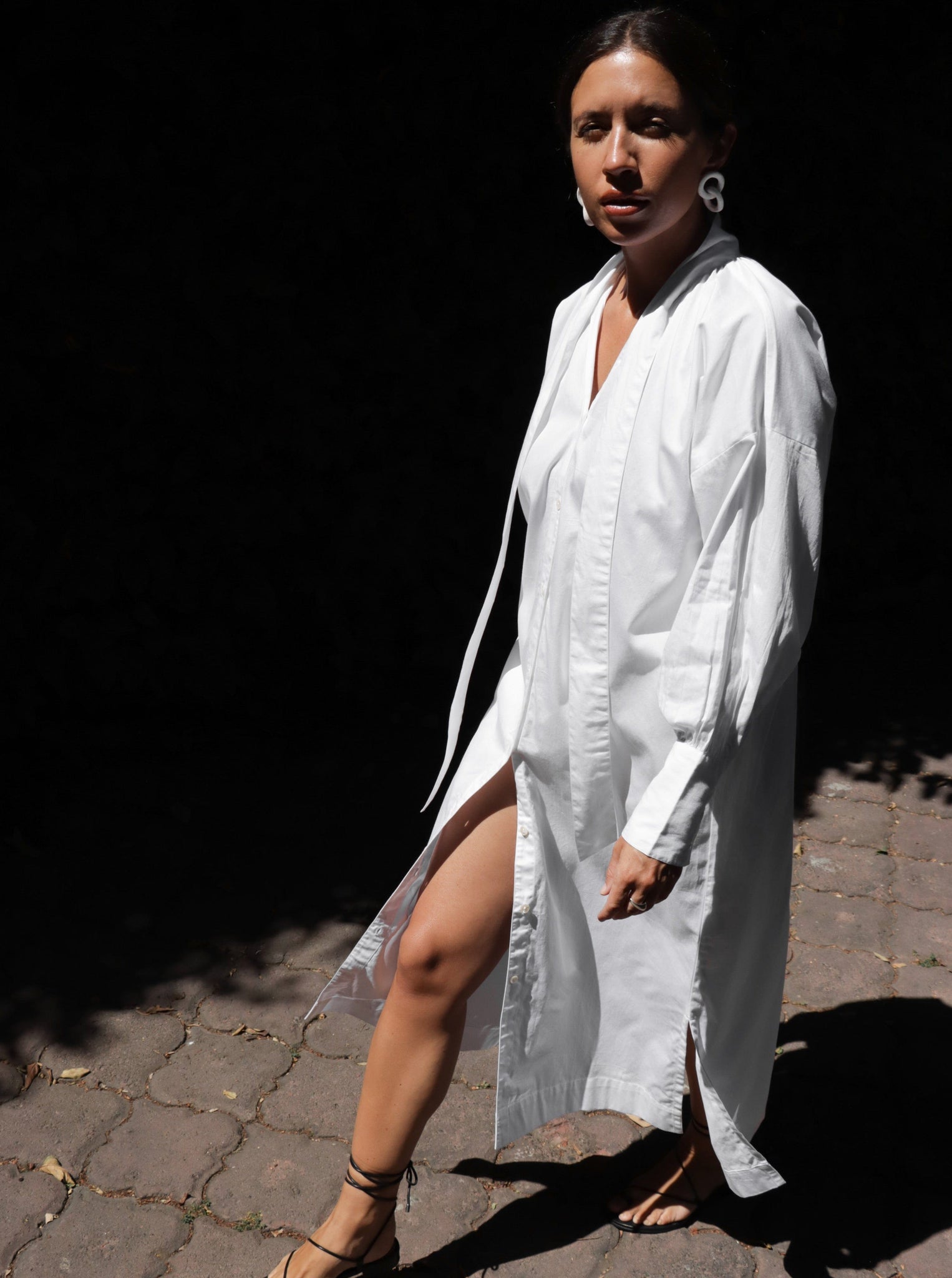 A woman wearing a Dolores Dress - White.