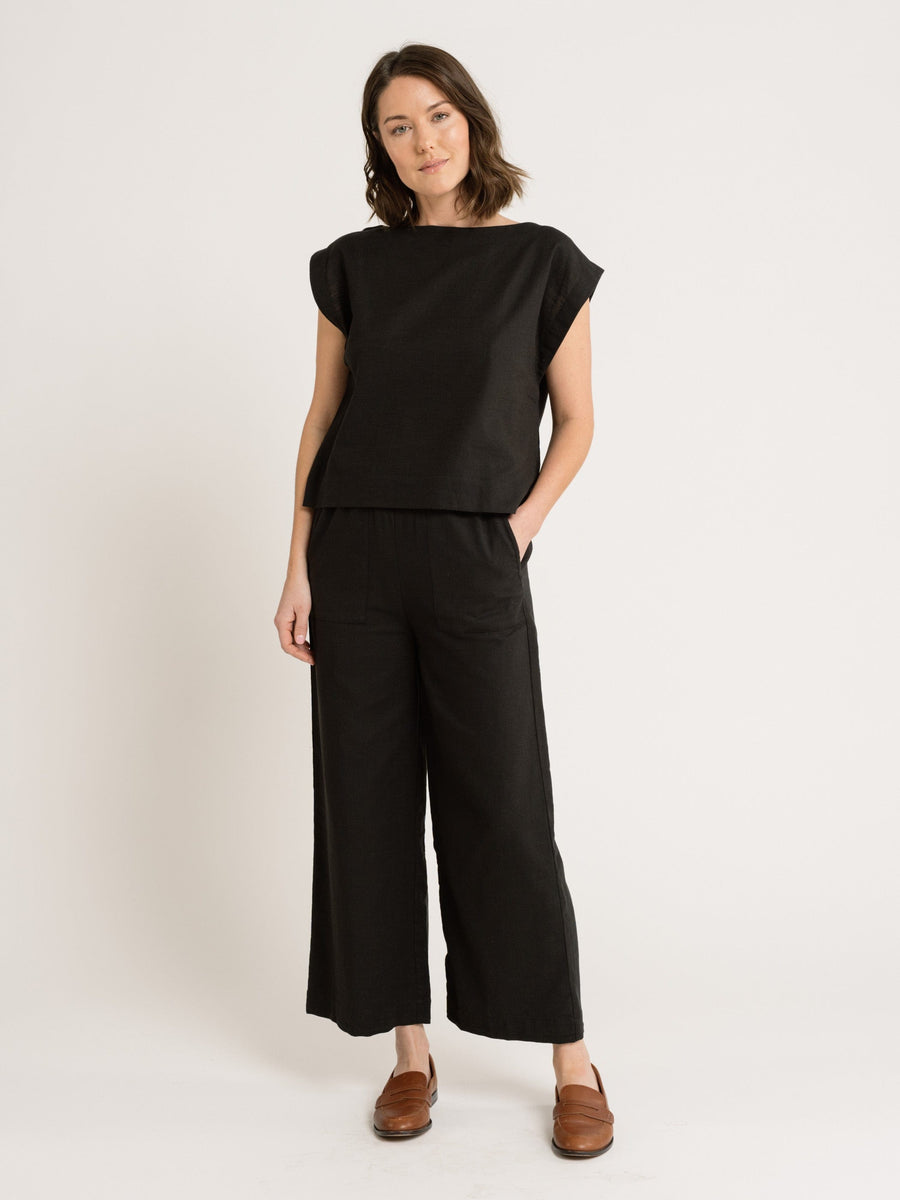 A woman wearing black linen wide-leg pants and the Everyday Top - Black.