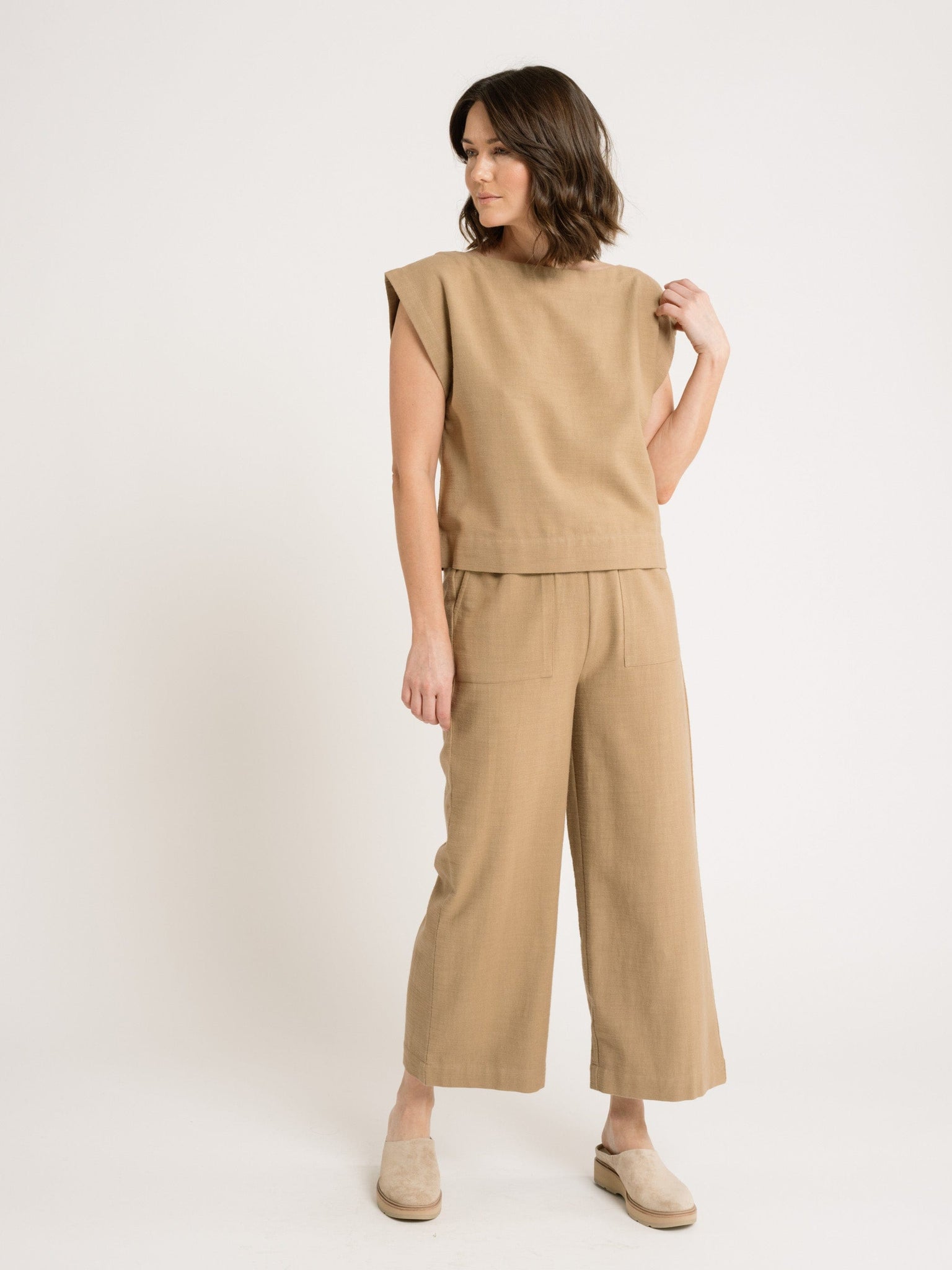 A woman wearing an Everyday Top - Tannin featuring a wide neckline.