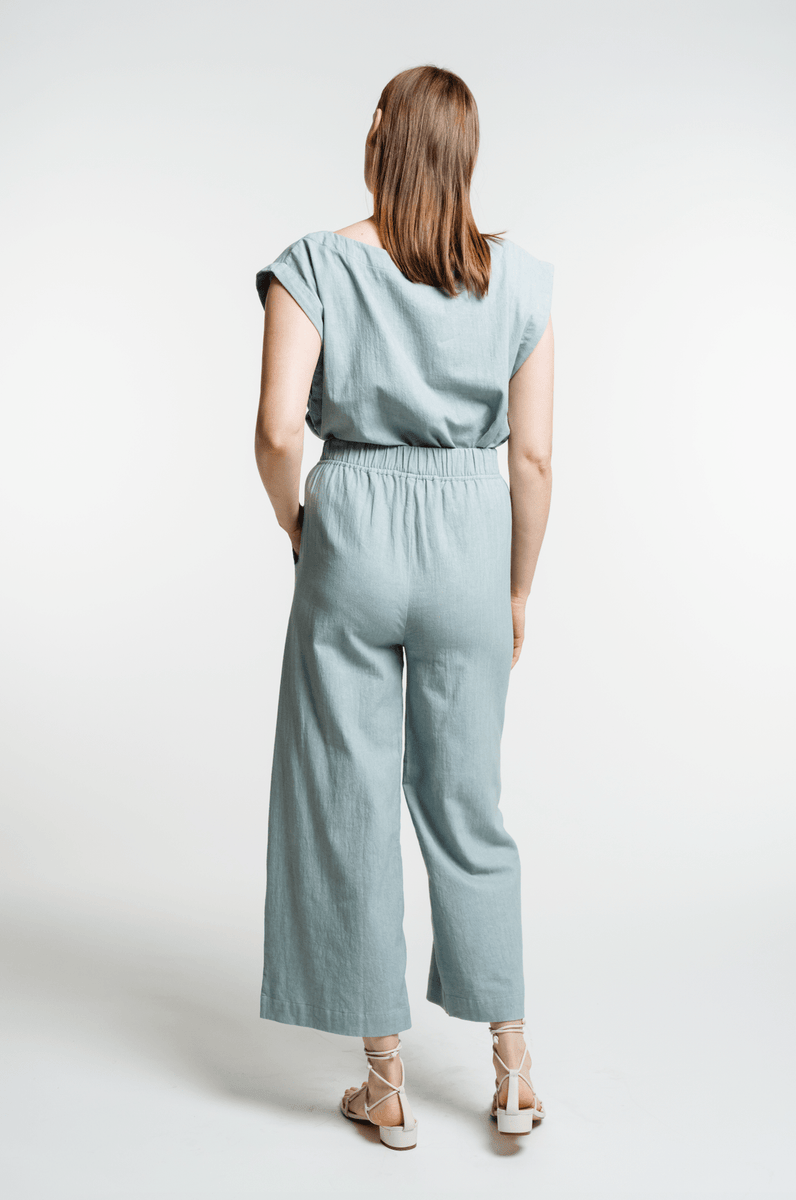 The back view of a woman wearing the Everyday Crop Pant - Cielo.