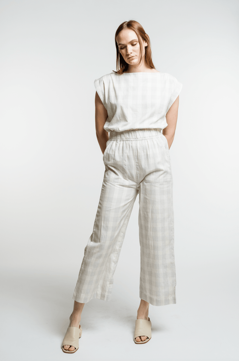 The model is wearing a white checkered Everyday Crop Pant - Rivera Plaid.