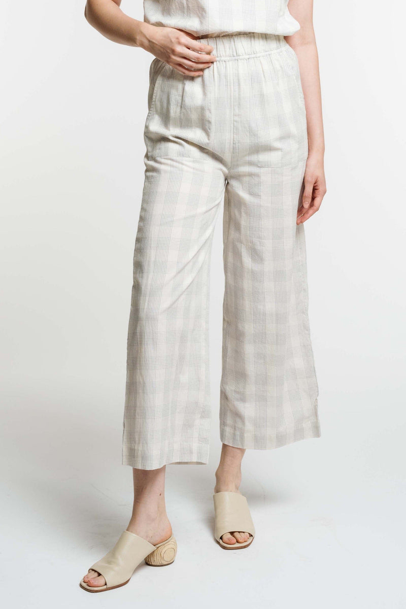 A woman wearing the Everyday Crop Pant - Rivera Plaid.