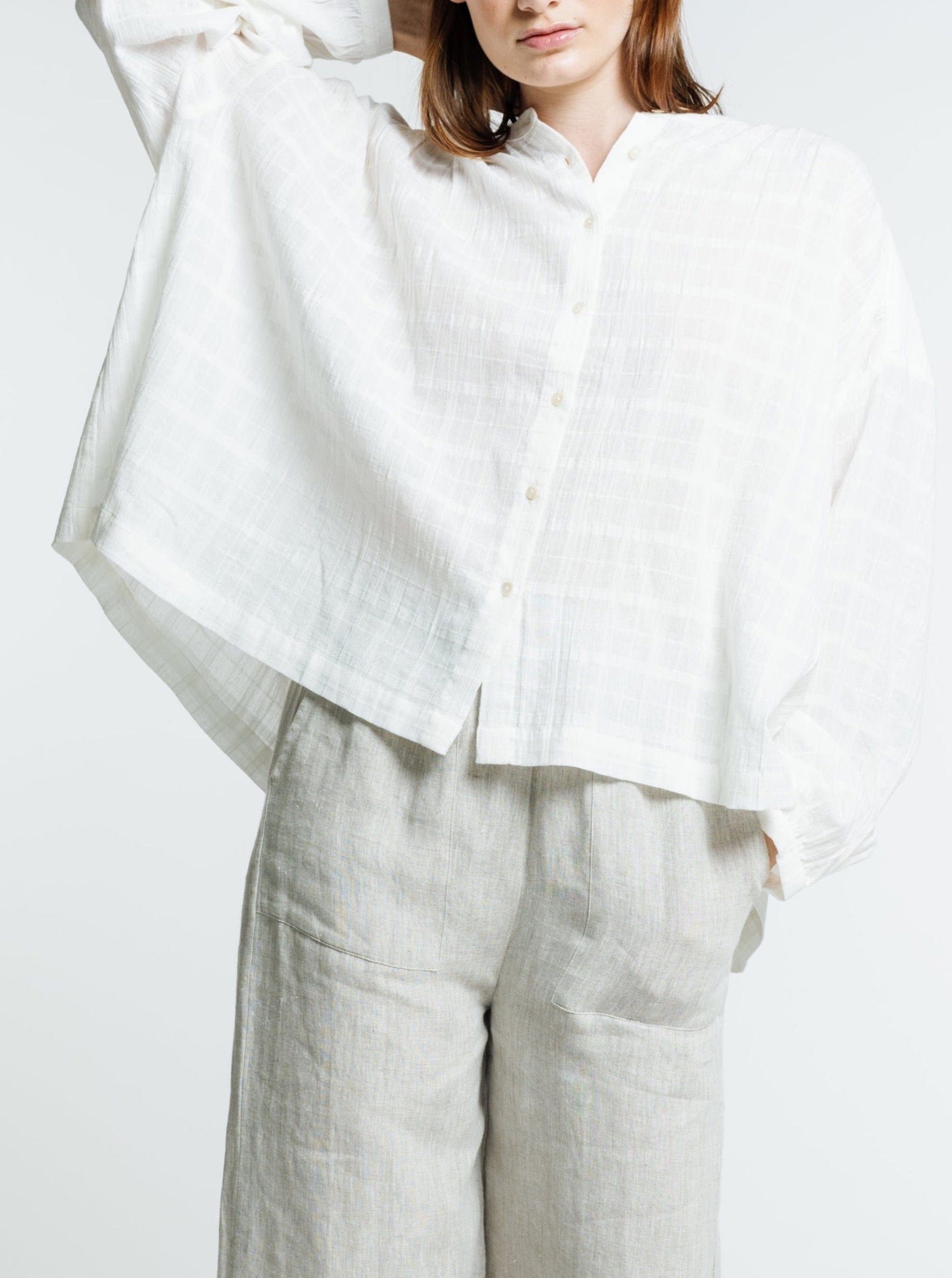 The model is wearing the Francoise Top - Alabaster Plaid and wide leg pants.