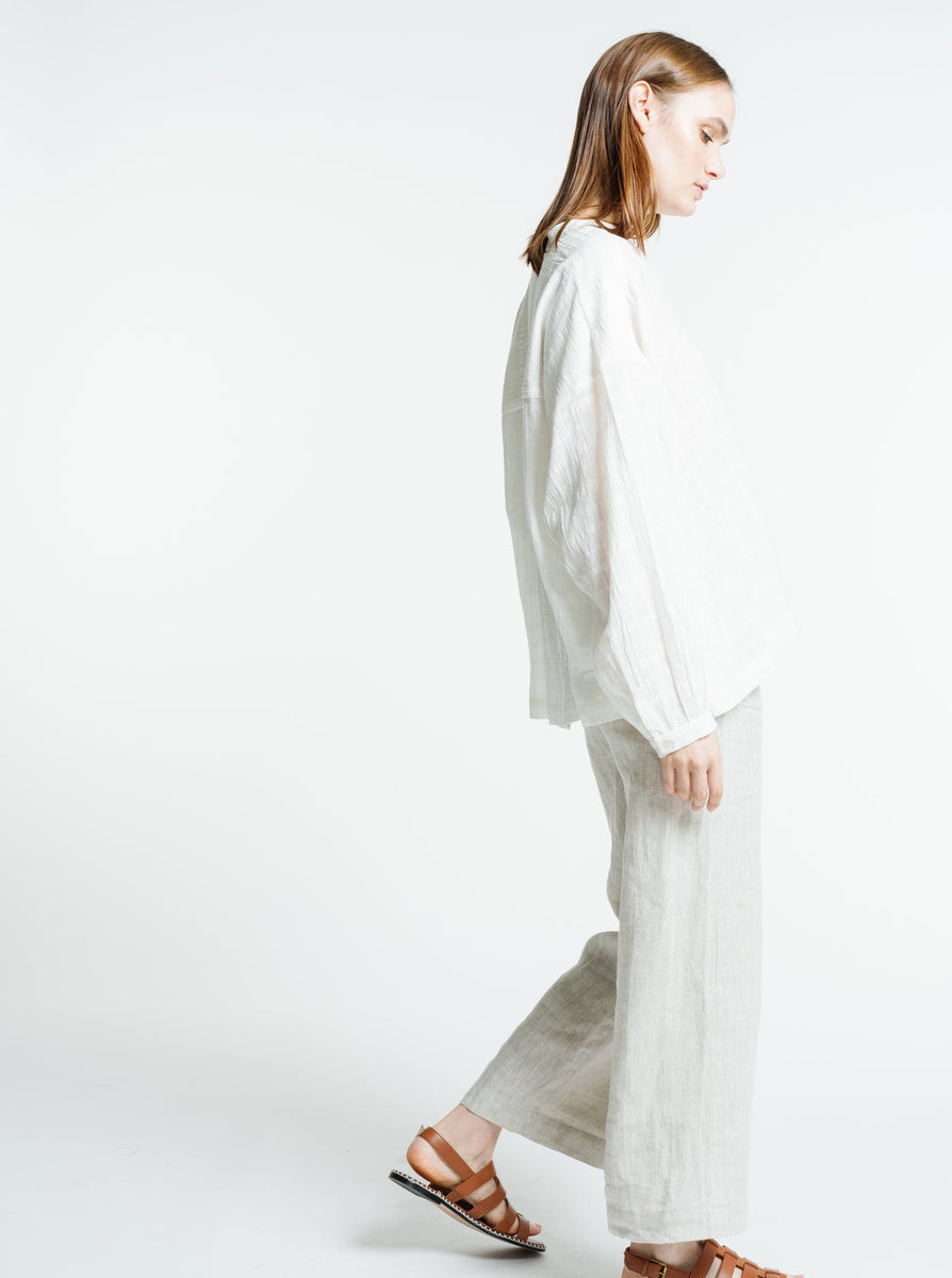 The model is wearing a white linen Francoise Top - Alabaster Plaid and wide leg pants.