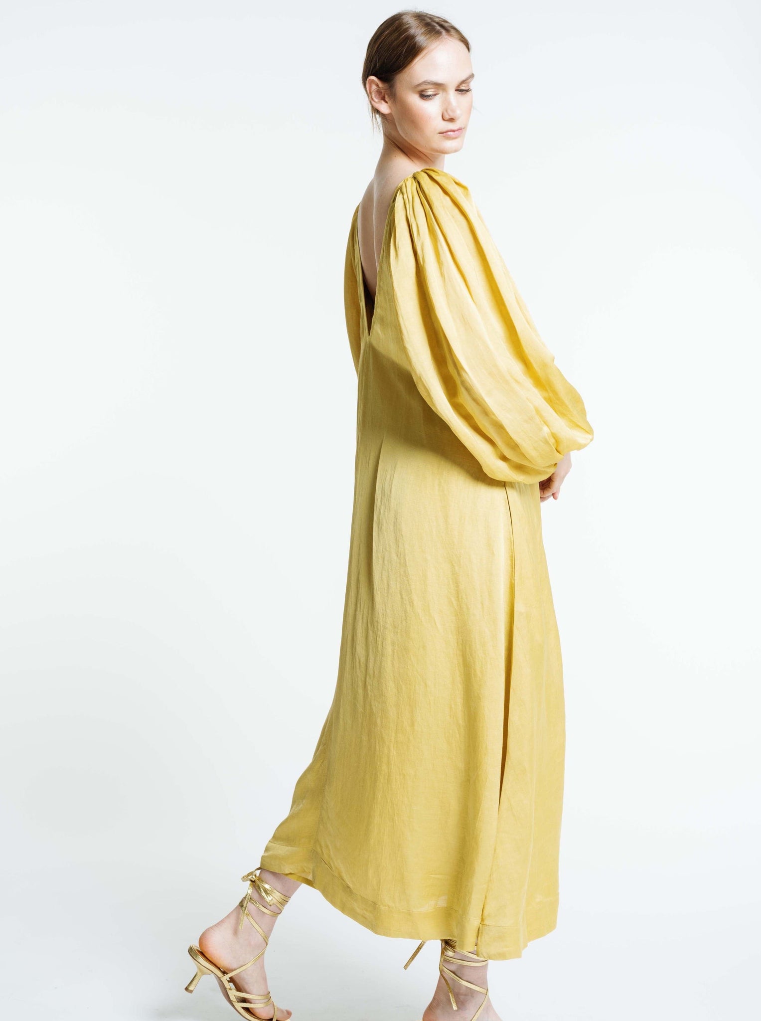The model is wearing a Lupita Maxi Dress - Citrine.